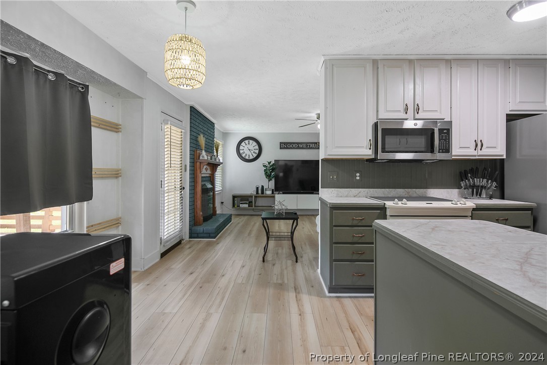 3011 Rouse Road Fayetteville, NC 28306 - Photo 19 of 50 a kitchen with a stove a sink and a refrigerator