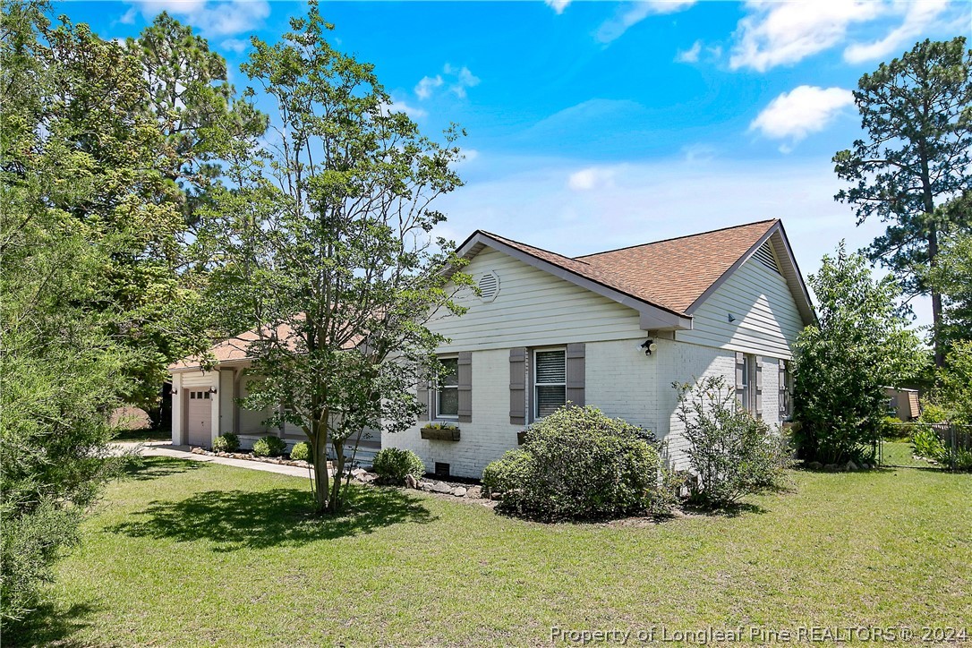 3011 Rouse Road Fayetteville, NC 28306 - Photo 2 of 50 a backyard of a house with plants and tree