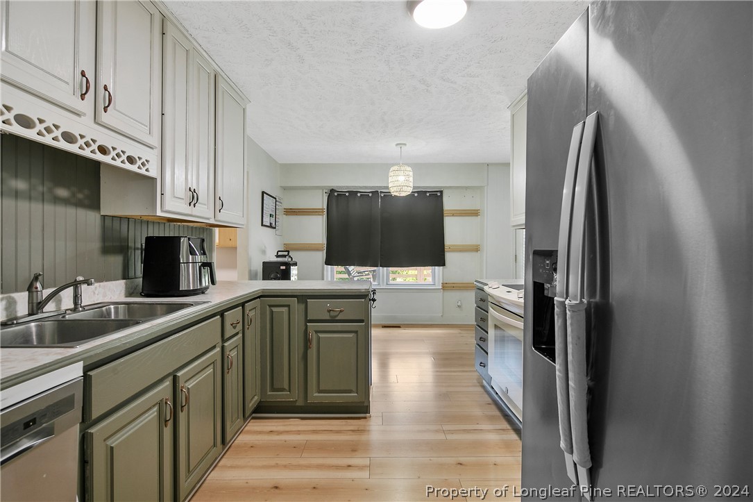 3011 Rouse Road Fayetteville, NC 28306 - Photo 24 of 50 a kitchen with stainless steel appliances a sink stove and refrigerator