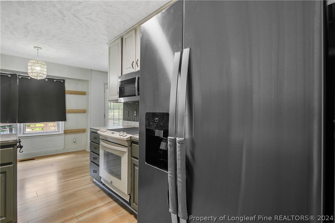 3011 Rouse Road Fayetteville, NC 28306 - Photo 25 of 50 a kitchen with stainless steel appliances granite countertop a refrigerator and a stove