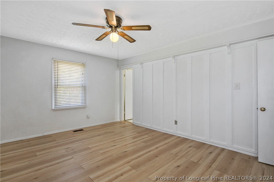 3011 Rouse Road Fayetteville, NC 28306 - Photo 28 of 50 an empty room with wooden floor fan and windows