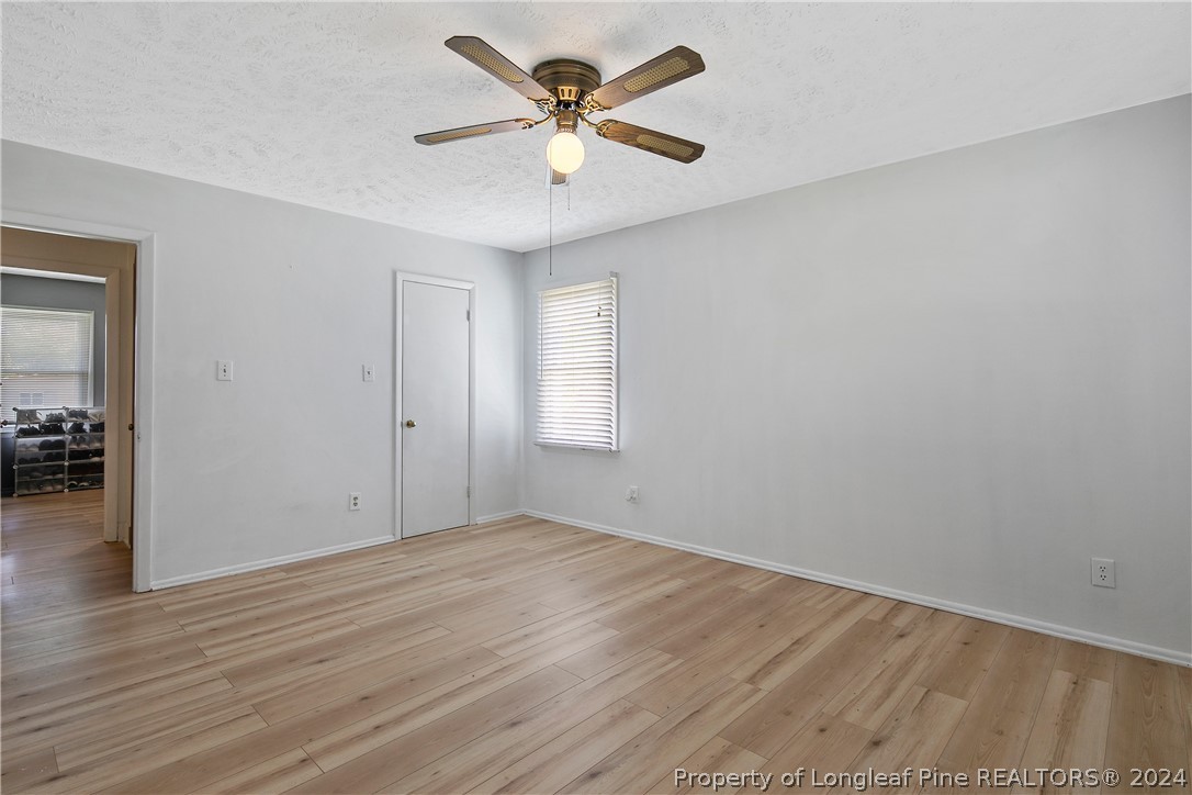 3011 Rouse Road Fayetteville, NC 28306 - Photo 30 of 50 an empty room with wooden floor and a ceiling fan