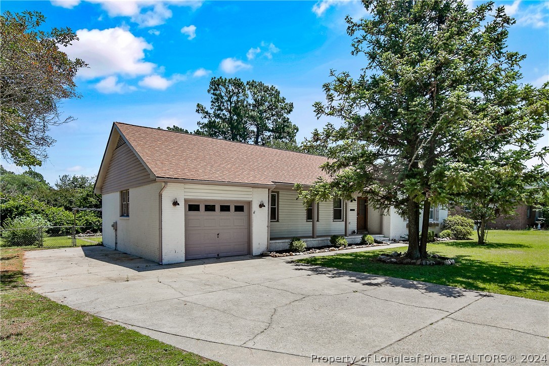 3011 Rouse Road Fayetteville, NC 28306 - Photo 3 of 50 a view of a white house with a yard and large tree
