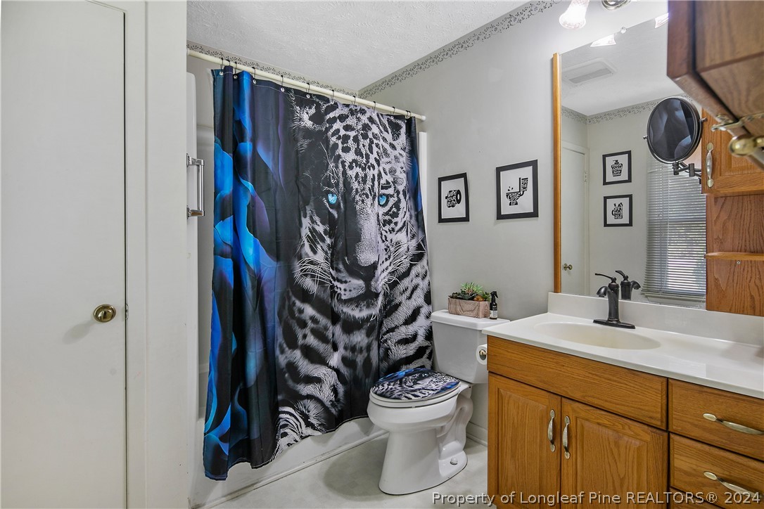 3011 Rouse Road Fayetteville, NC 28306 - Photo 31 of 50 a bathroom with a toilet sink and mirror