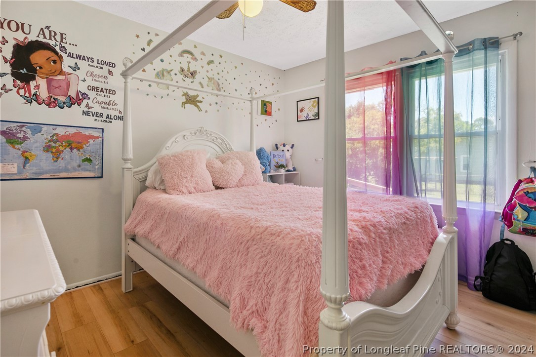 3011 Rouse Road Fayetteville, NC 28306 - Photo 34 of 50 a bedroom with a bed and a painting on the wall
