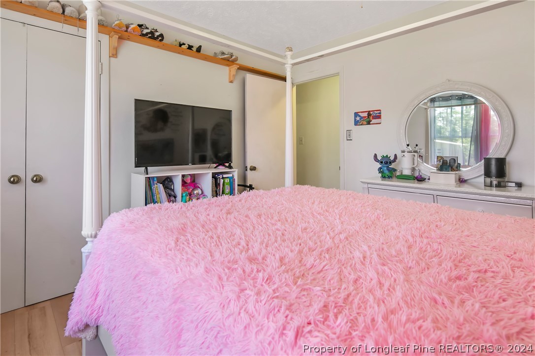 3011 Rouse Road Fayetteville, NC 28306 - Photo 36 of 50 a bedroom with a bed and a flat screen tv