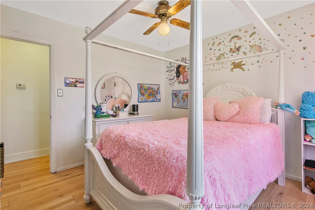 3011 Rouse Road Fayetteville, NC 28306 - Photo 37 of 50 a bedroom with a bed and wooden floor