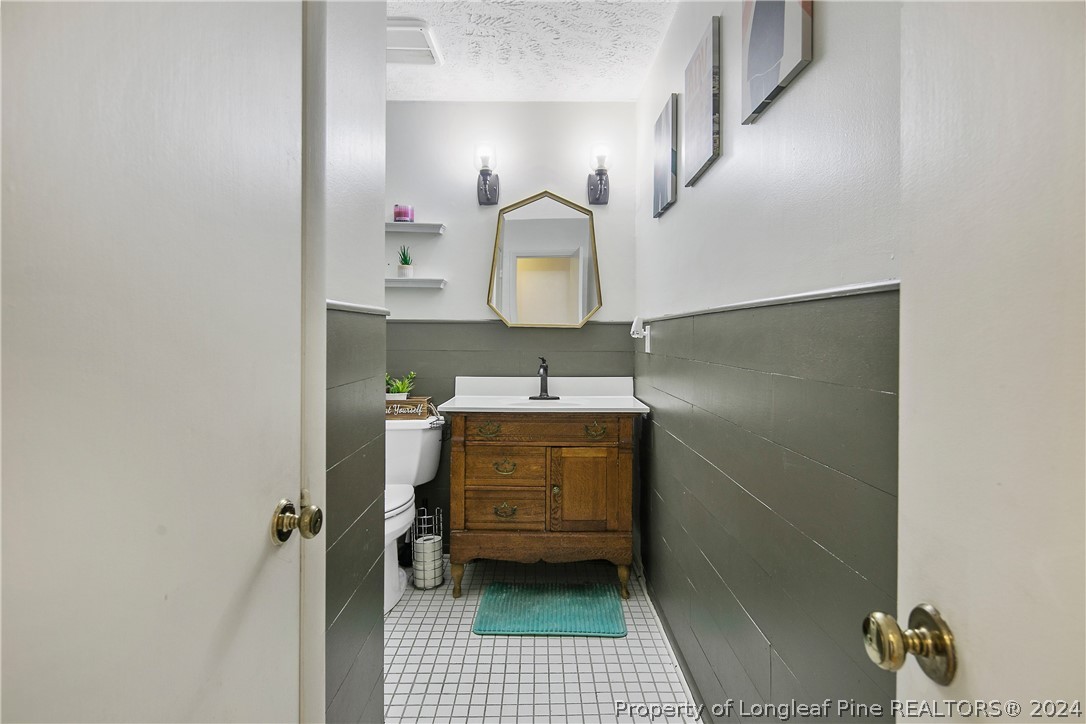 3011 Rouse Road Fayetteville, NC 28306 - Photo 38 of 50 a bathroom with a sink a toilet and mirror