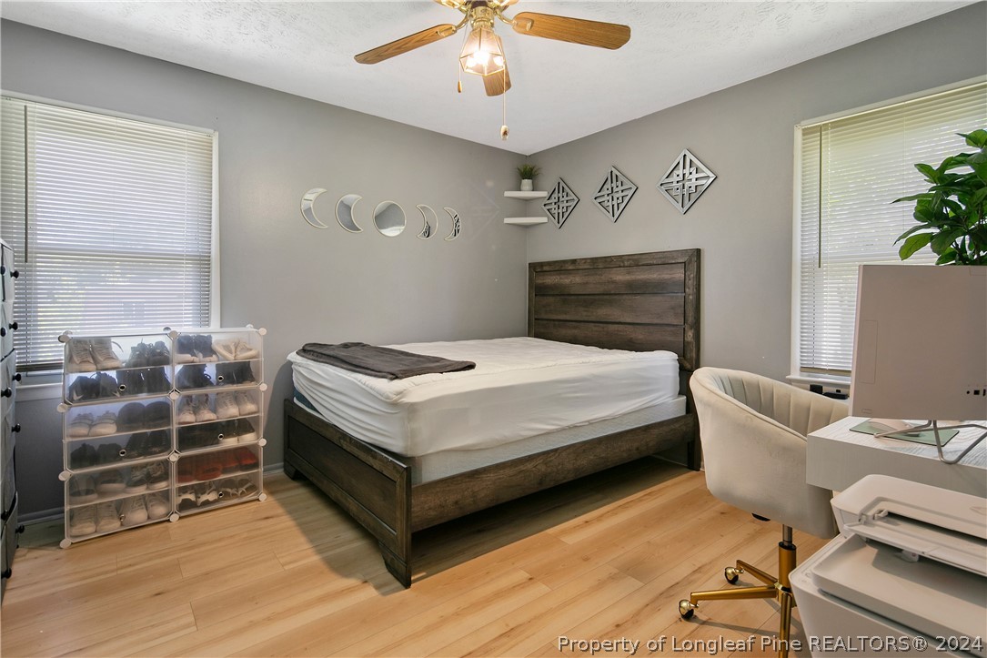 3011 Rouse Road Fayetteville, NC 28306 - Photo 40 of 50 a bedroom with a bed and a chandelier