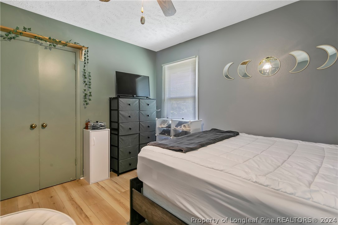 3011 Rouse Road Fayetteville, NC 28306 - Photo 42 of 50 a bedroom with a bed and a chandelier