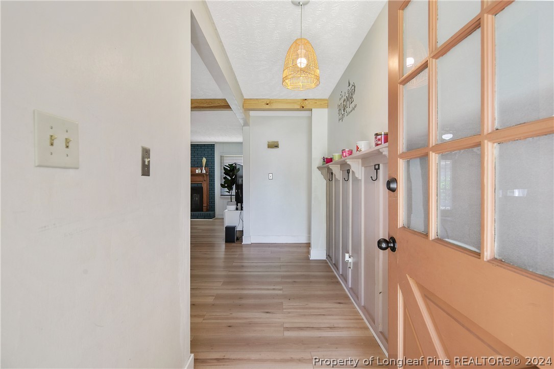 3011 Rouse Road Fayetteville, NC 28306 - Photo 5 of 50 a view of a hallway with entryway wooden floor and front door