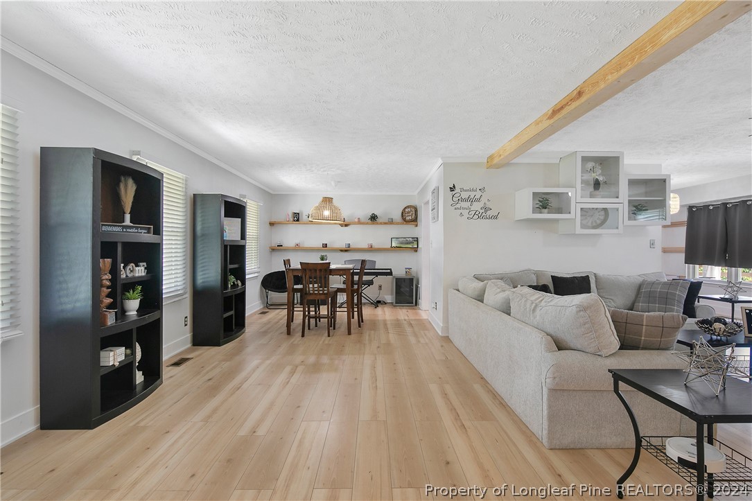 3011 Rouse Road Fayetteville, NC 28306 - Photo 8 of 50 a living room with furniture and a wooden floor