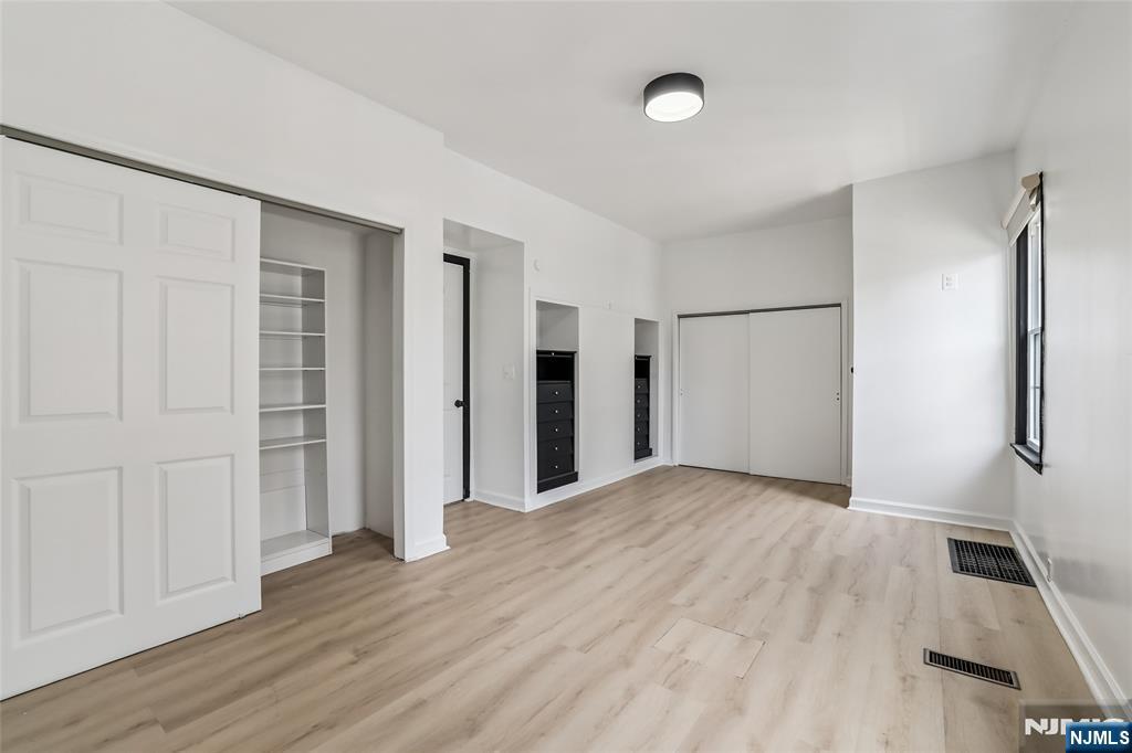11 Garden Street, Unit 1 Ridgefield Park, NJ 07660 - Photo 12 of 20 a view of an empty room with wooden floor and a window