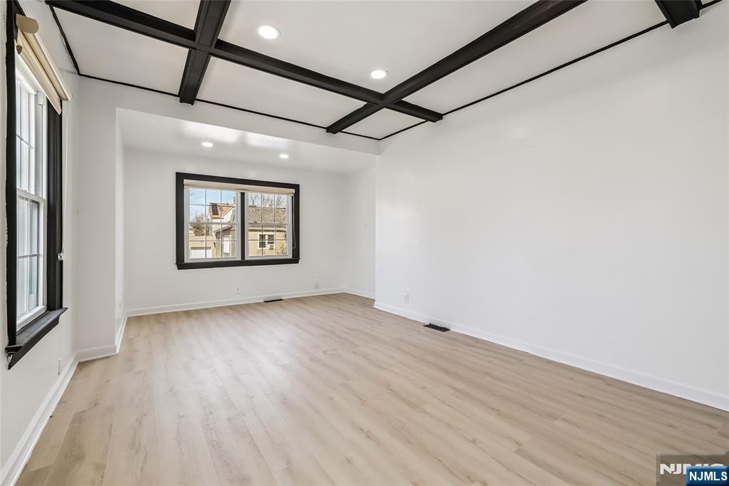 11 Garden Street, Unit 1 Ridgefield Park, NJ 07660 - Photo 17 of 20 an empty room with wooden floor and windows
