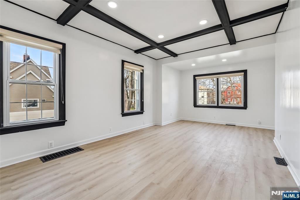 11 Garden Street, Unit 1 Ridgefield Park, NJ 07660 - Photo 18 of 20 a view of an empty room with a window and wooden floor