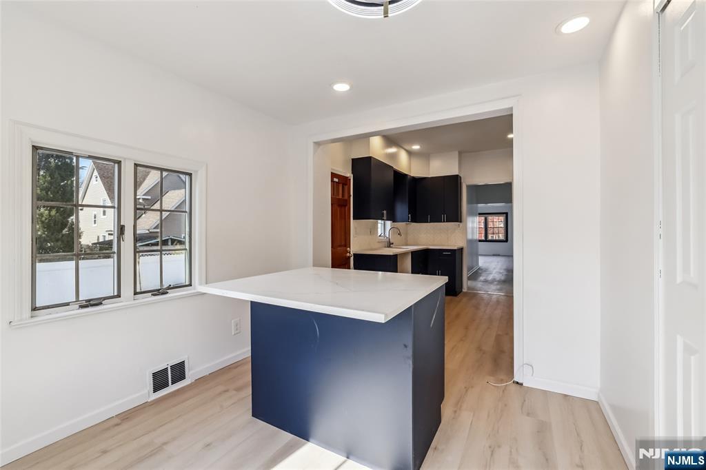 11 Garden Street, Unit 1 Ridgefield Park, NJ 07660 - Photo 3 of 20 a room with kitchen island sink and wooden floor