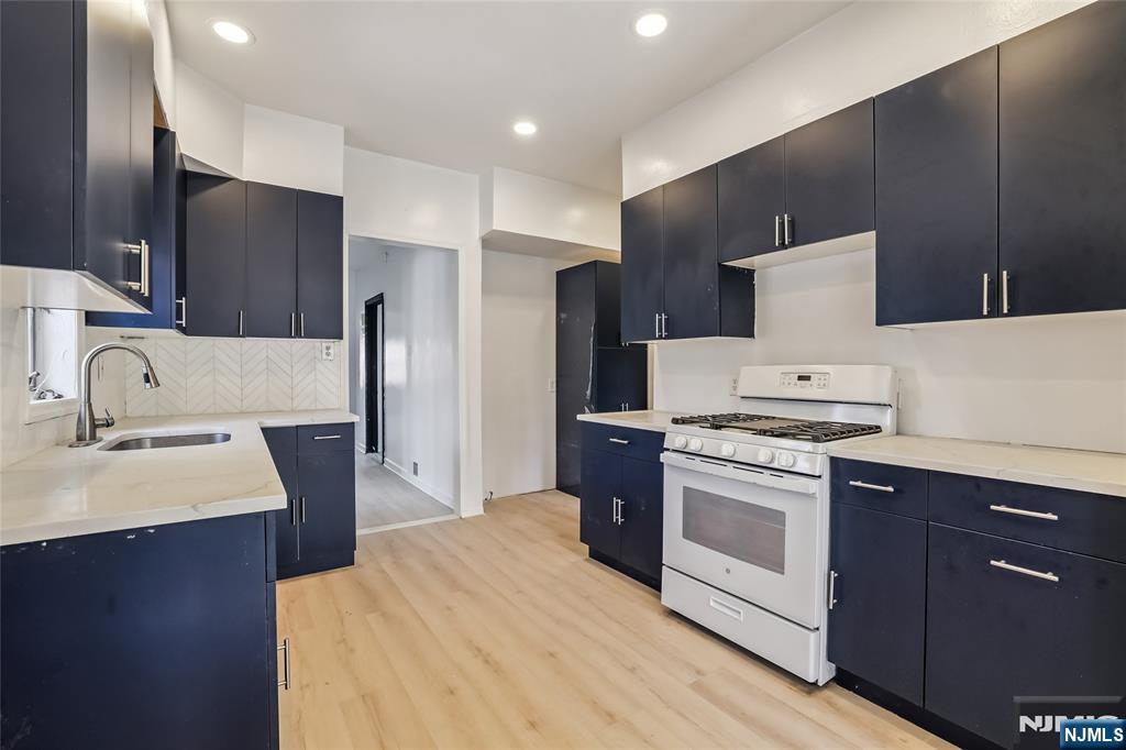 11 Garden Street, Unit 1 Ridgefield Park, NJ 07660 - Photo 6 of 20 a kitchen with stainless steel appliances a sink stove and refrigerator