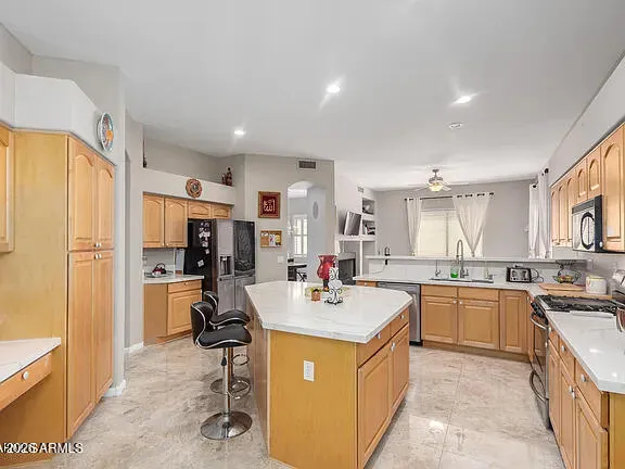 a kitchen with a sink a counter top stainless steel appliances and cabinets