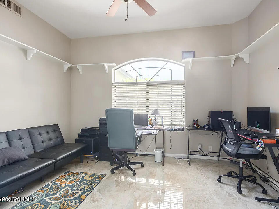 755 East Orchid Lane Gilbert, AZ 85296 - Photo 16 of 26 a view of a workspace with furniture and a window