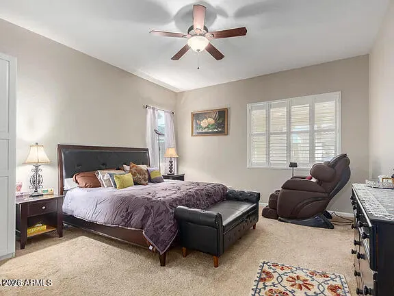 a bedroom with a bed a couch and a chandelier