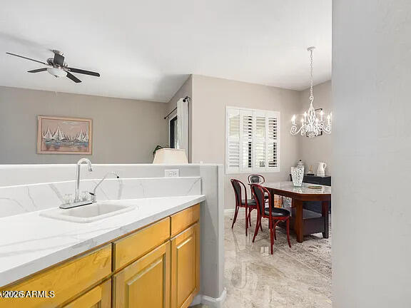 755 East Orchid Lane Gilbert, AZ 85296 - Photo 18 of 26 a view of a dining room with furniture and chandelier