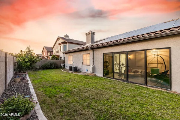 a view of a house with backyard and porch