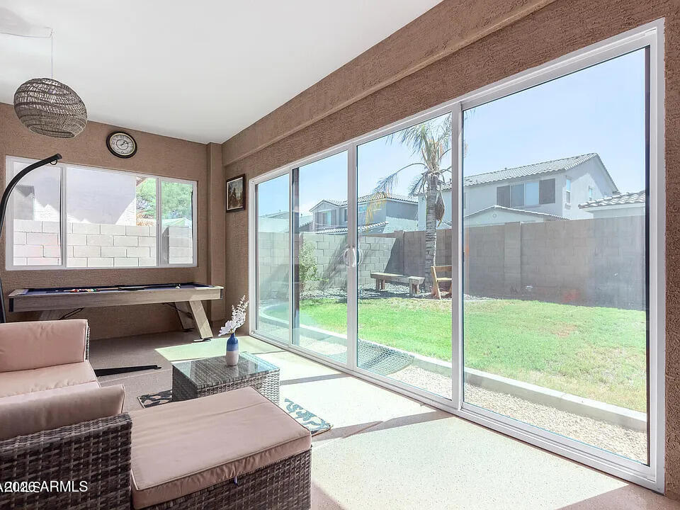 755 East Orchid Lane Gilbert, AZ 85296 - Photo 9 of 26 a living room with furniture and a floor to ceiling window