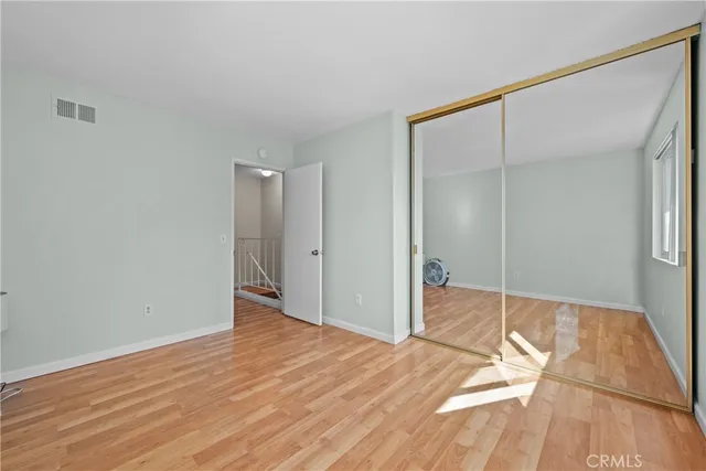 a view of a room with wooden floor and bathroom