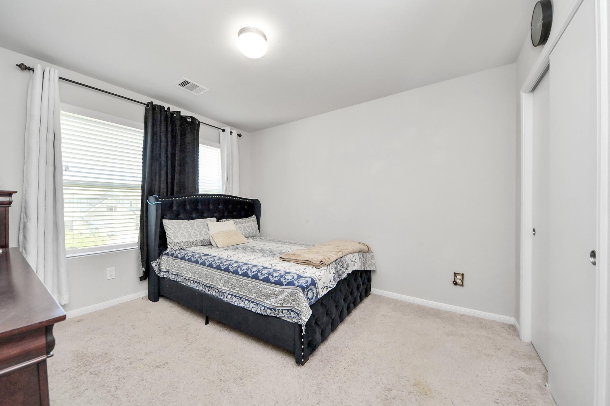 2643 Ridgeback Drive Rosenberg, TX 77471 - Photo 35 of 46 a spacious bedroom with a bed lamp and a window
