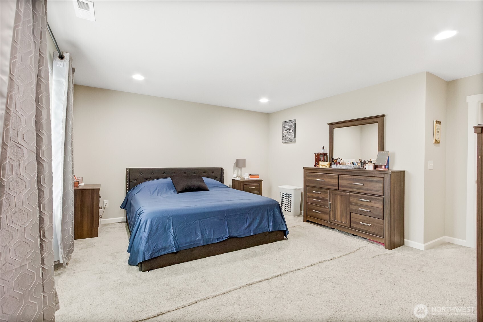 5014 Kenrick Street Southeast Lacey, WA 98503 - Photo 17 of 22 a bedroom with a bed and dresser with mirror