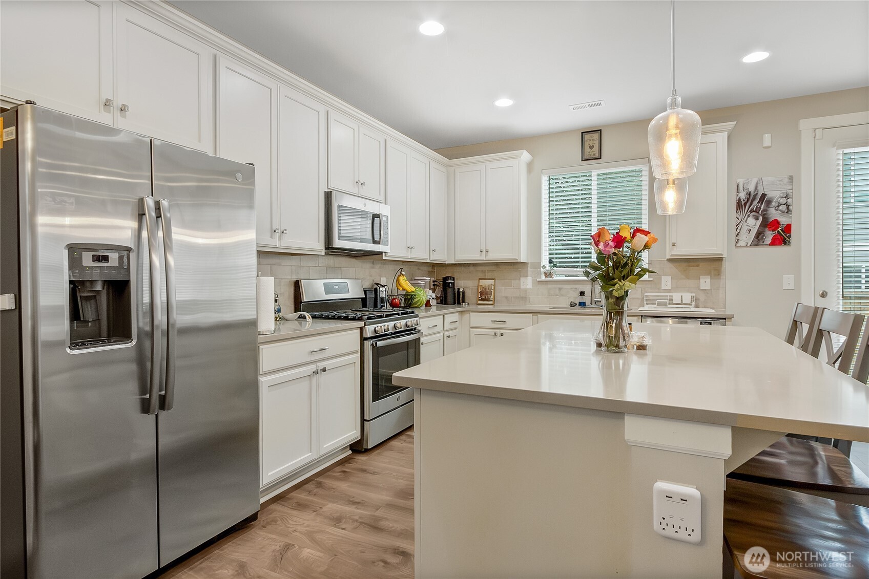 5014 Kenrick Street Southeast Lacey, WA 98503 - Photo 6 of 22 a kitchen with kitchen island a counter top space cabinets and stainless steel appliances