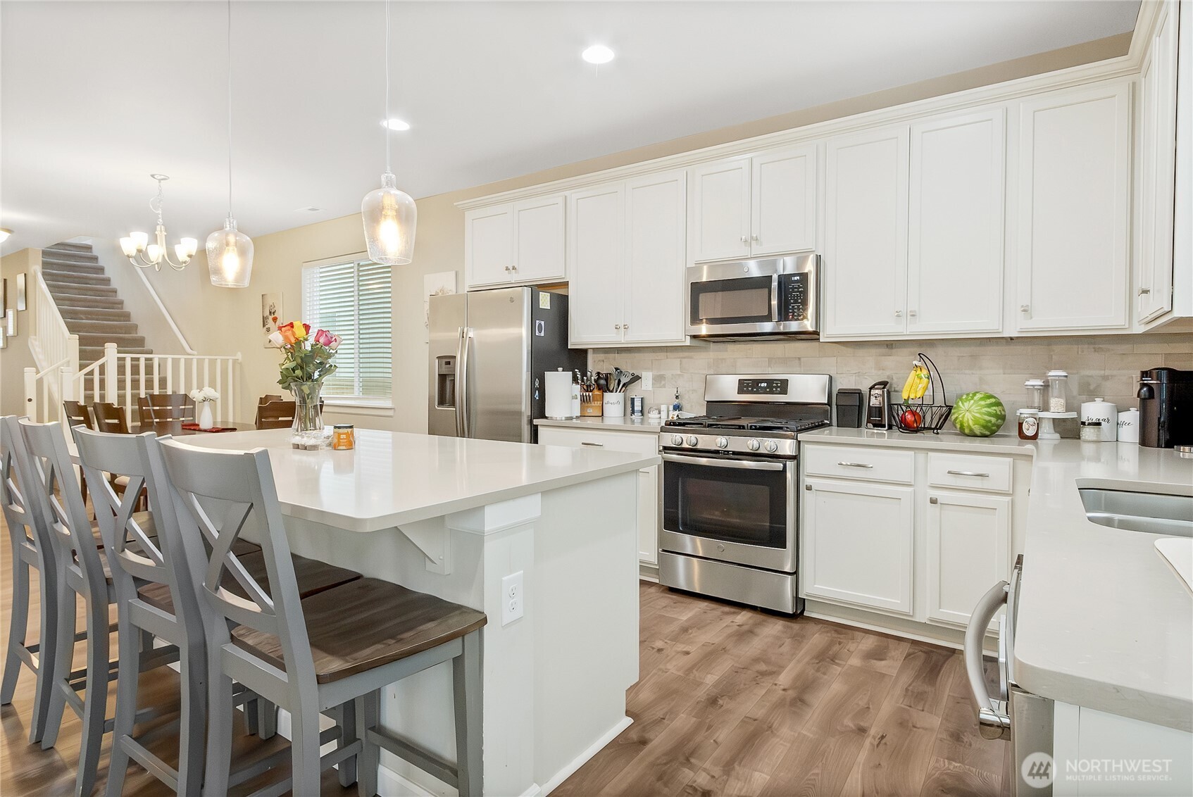 5014 Kenrick Street Southeast Lacey, WA 98503 - Photo 7 of 22 a kitchen with stainless steel appliances a stove a sink a microwave a refrigerator and cabinets