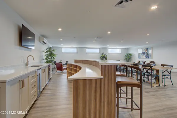 a living room with furniture a couch and kitchen view