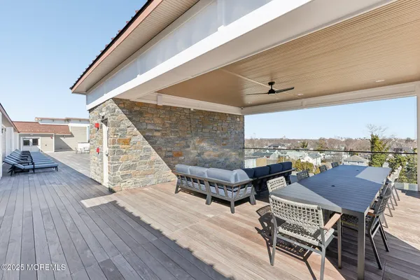 a kitchen with stainless steel appliances granite countertop a table chairs and a refrigerator
