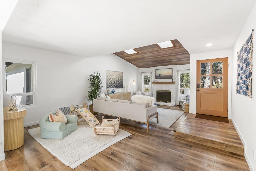 1427 Avocado Road Oceanside, CA 92054 - Photo 12 of 57 a living room with furniture and a fireplace