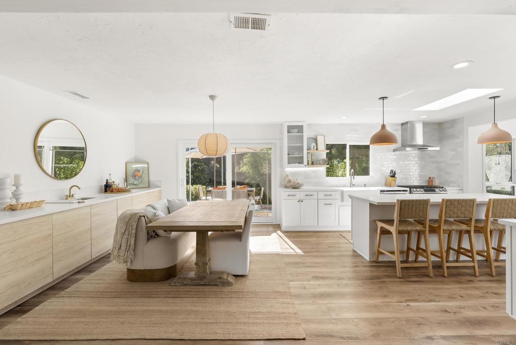 1427 Avocado Road Oceanside, CA 92054 - Photo 17 of 57 a dining hall with stainless steel appliances kitchen island granite countertop a stove and white cabinets