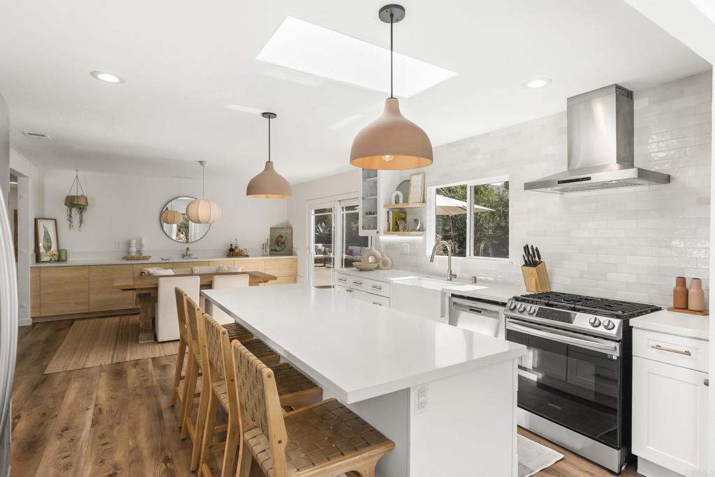 1427 Avocado Road Oceanside, CA 92054 - Photo 23 of 57 a kitchen with stainless steel appliances granite countertop a sink a stove and a wooden floors