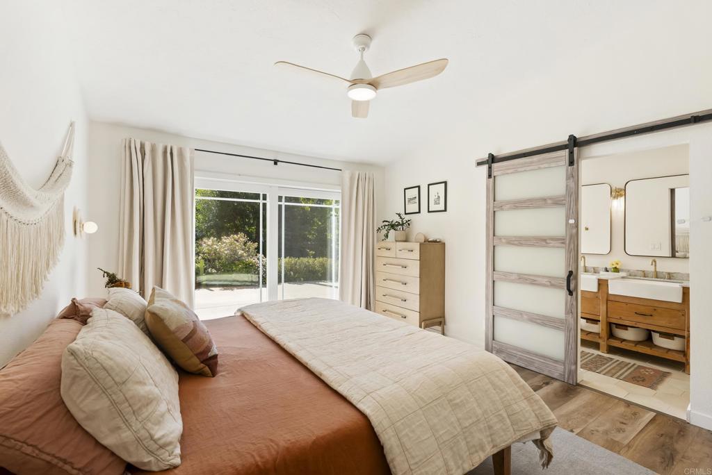 1427 Avocado Road Oceanside, CA 92054 - Photo 29 of 57 a bedroom with a bed dresser and a large window