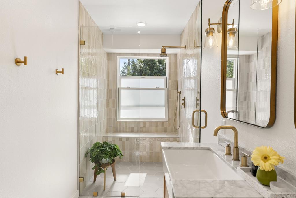 1427 Avocado Road Oceanside, CA 92054 - Photo 33 of 57 a bathroom with a tub sink and mirror