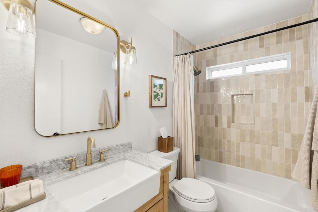 1427 Avocado Road Oceanside, CA 92054 - Photo 35 of 57 a bathroom with a granite countertop sink toilet and shower
