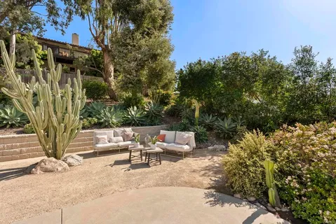 a view of a white house with a yard