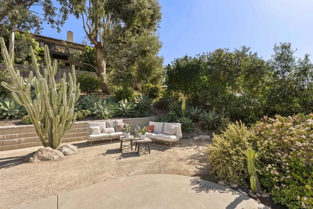 1427 Avocado Road Oceanside, CA 92054 - Photo 37 of 57 a backyard of a house with table and chairs