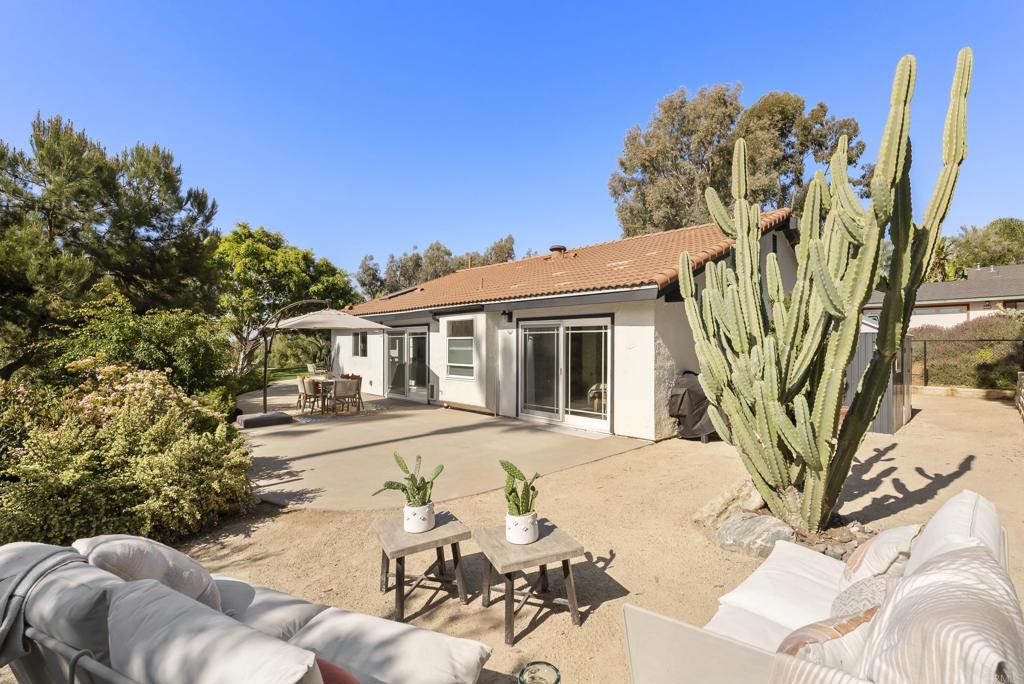 1427 Avocado Road Oceanside, CA 92054 - Photo 38 of 57 a view of a white house with a yard