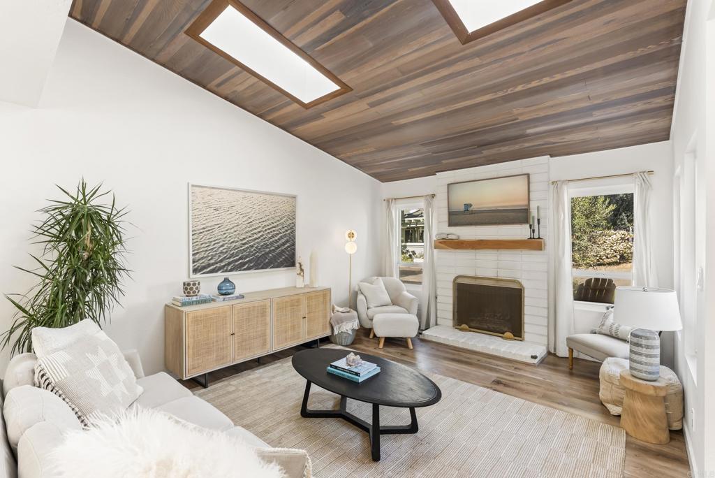 1427 Avocado Road Oceanside, CA 92054 - Photo 9 of 57 a living room with furniture a rug and a fireplace