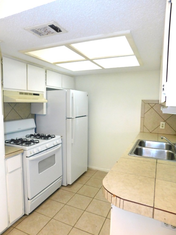 8208 Hood Circle, Unit A Austin, TX 78745 - Photo 2 of 14 a kitchen with a stove and a refrigerator