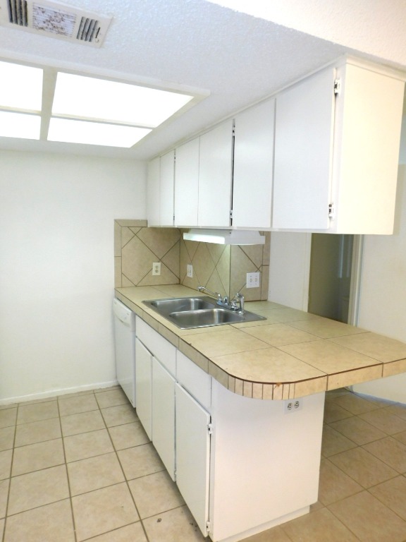 8208 Hood Circle, Unit A Austin, TX 78745 - Photo 3 of 14 a kitchen with a sink a stove and cabinets