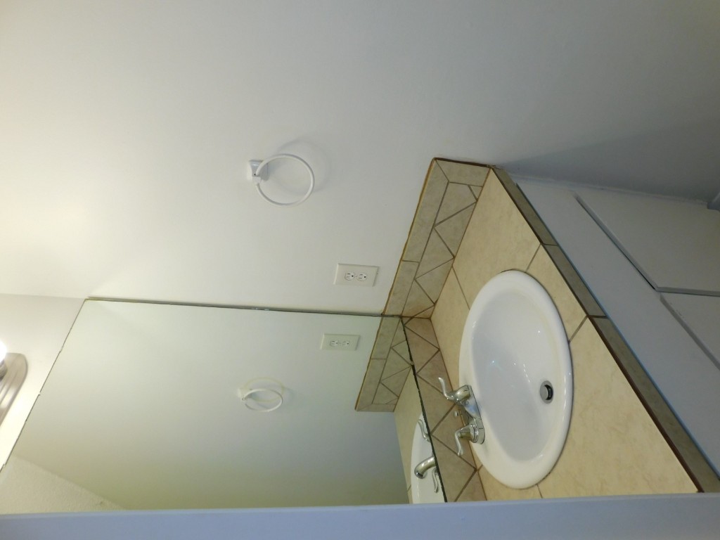 8208 Hood Circle, Unit A Austin, TX 78745 - Photo 6 of 14 a bathroom with a sink and a mirror