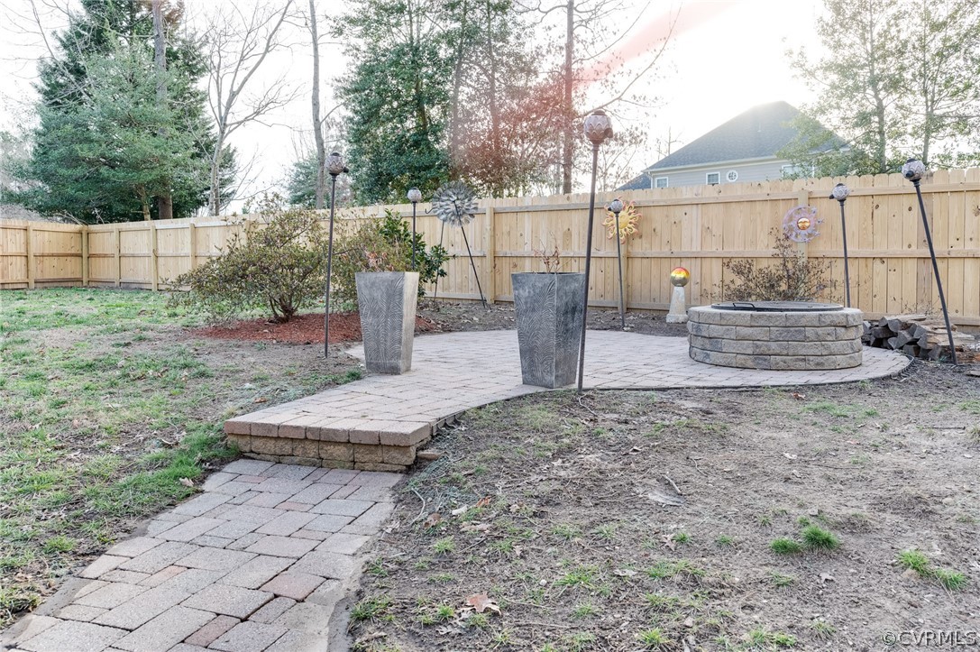 12124 Club Ridge Drive Chester, VA 23836 - Photo 40 of 40 Built-in Fire pit with extra wood to make marshmallow smores