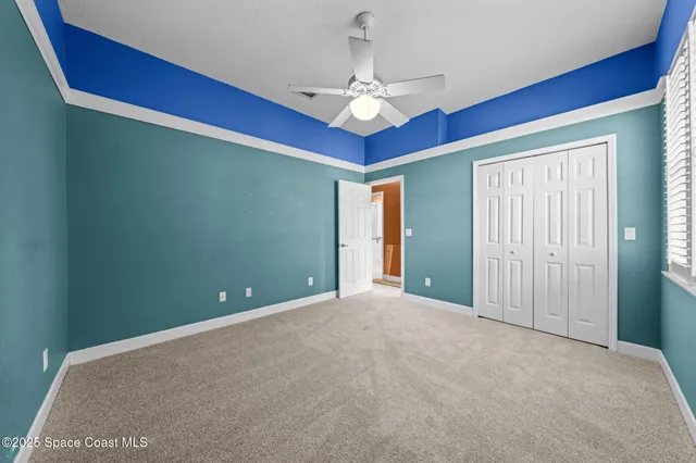 a spacious bathroom with a granite countertop sink a toilet a mirror and shower