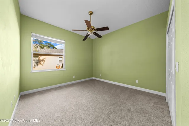 a view of a room with a ceiling fan